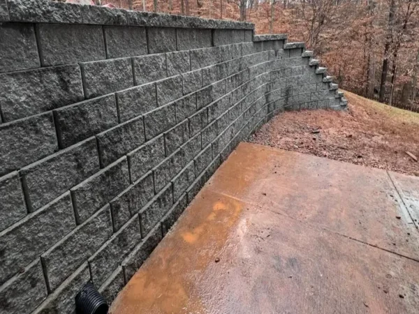 Retaining wall with integrated drainage outlets in Atlanta area.