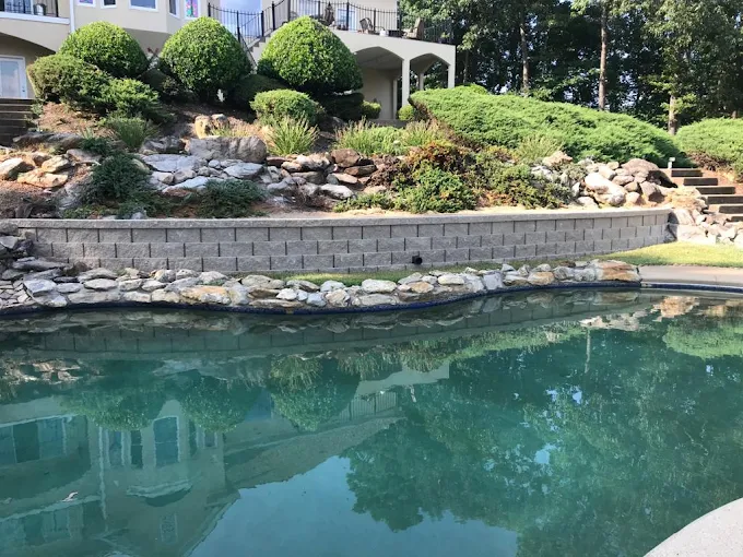 Retaining wall with integrated drainage outlets in Atlanta area.