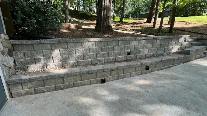 Retaining wall with integrated drainage outlets in Atlanta area.