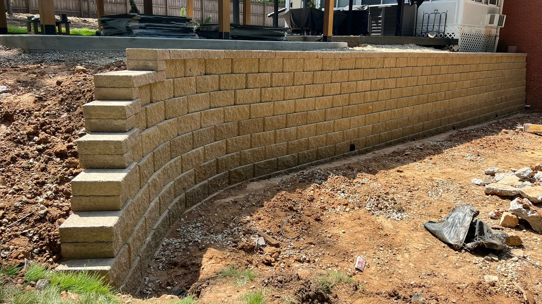 Retaining wall built on a sloped backyard in Atlanta using segmental blocks